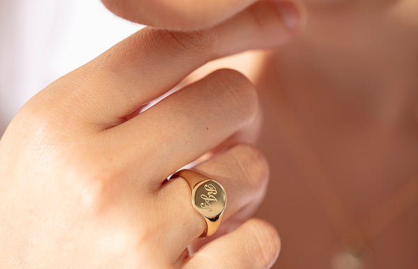 Model wearing engraved signet ring