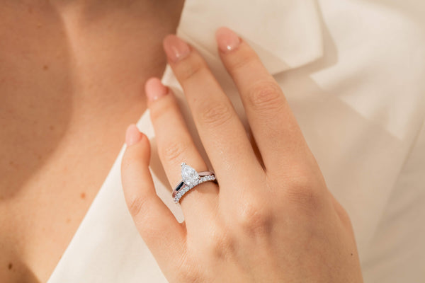 Model wearing diamond wedding and engagement rings