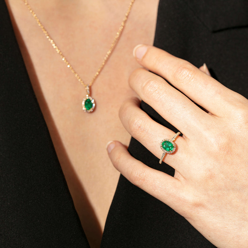 Model wearing emerald and diamond Mini Sierra Ring and Pendant