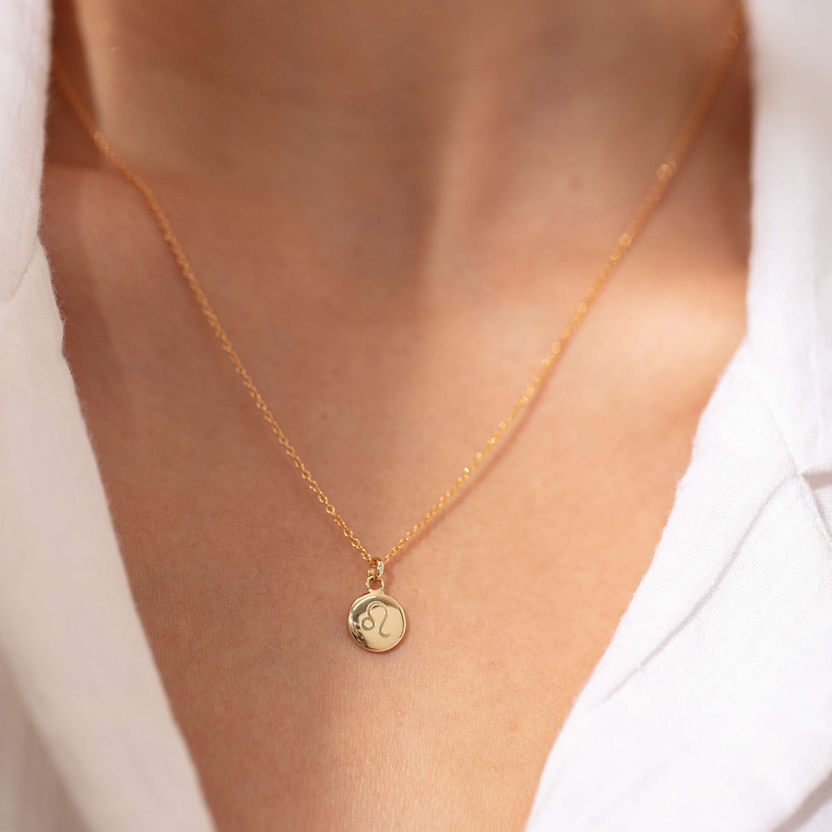 Model wearing engraved yellow gold Pebble Pendant