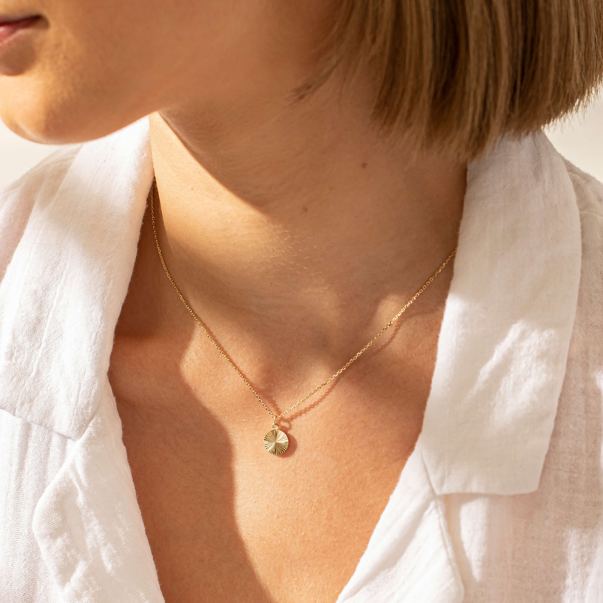 Model wearing yellow gold Reflections pendant