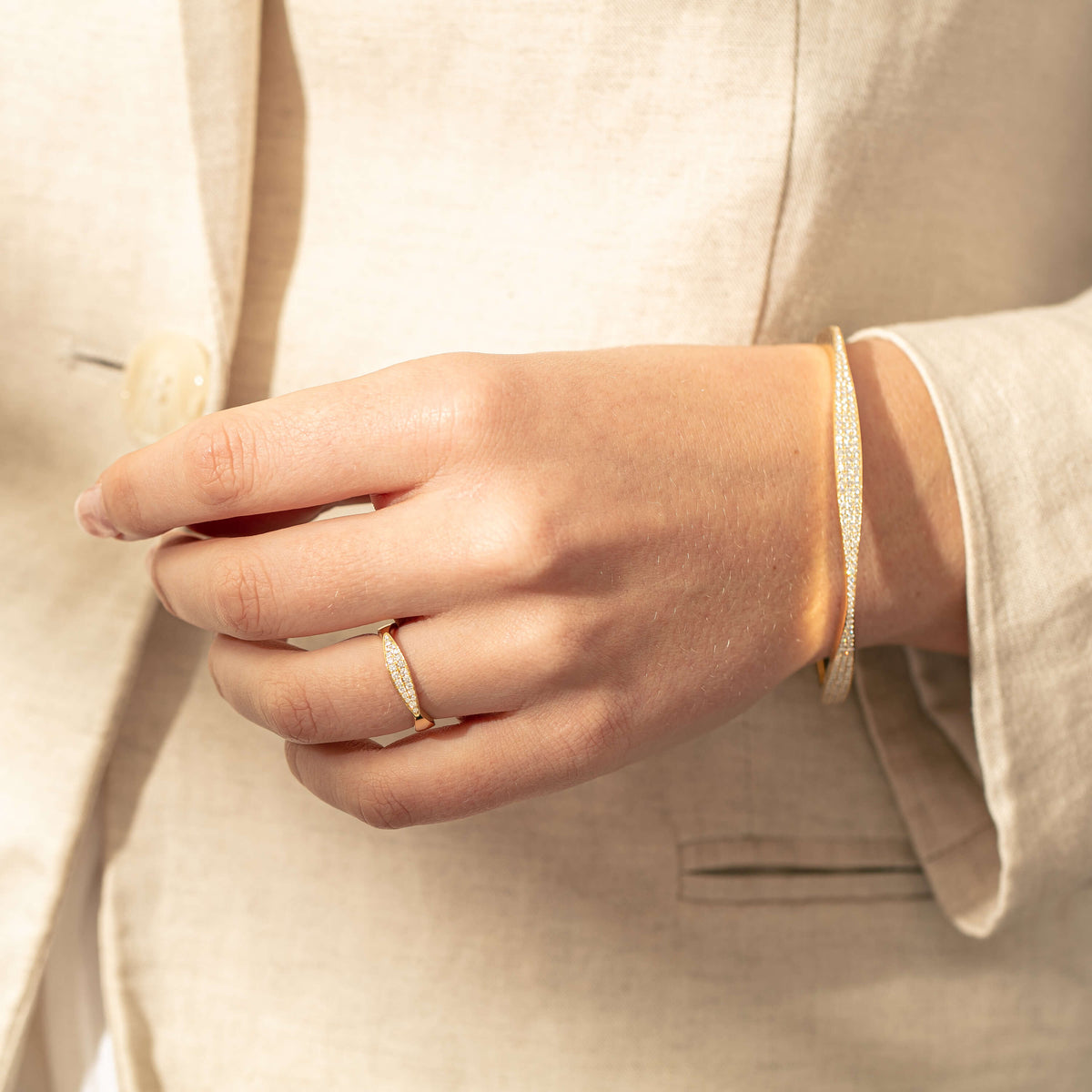 Model wearing diamond Eos ring and bangle