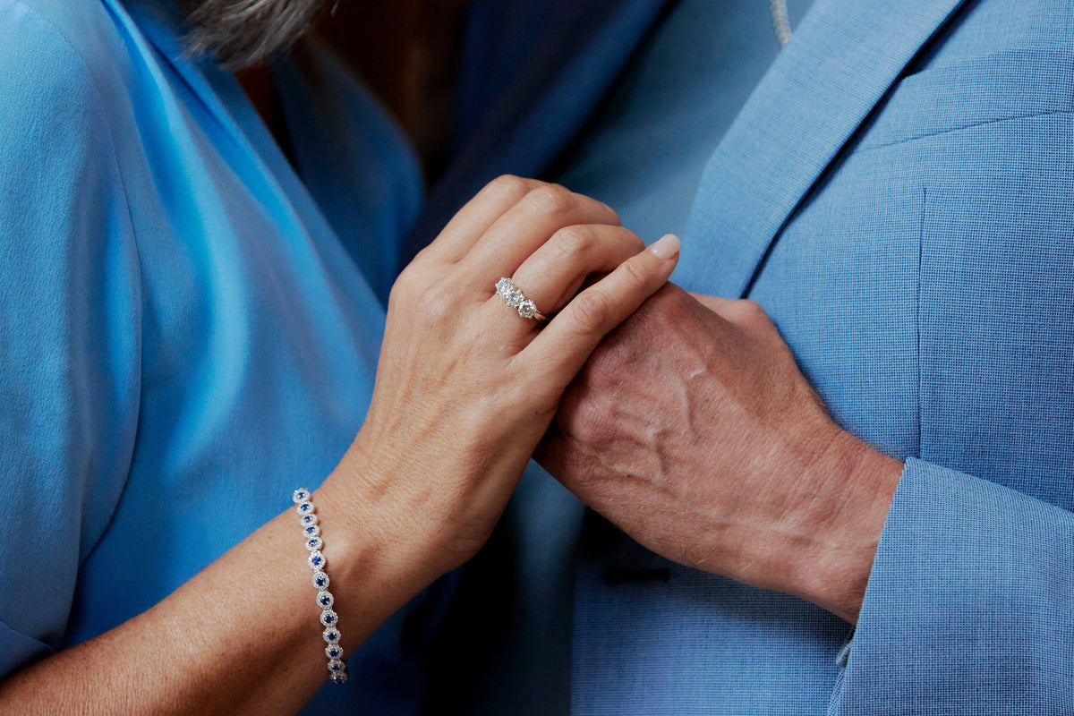 Couple holding hands, model wearing Diamond Trilogy Ring