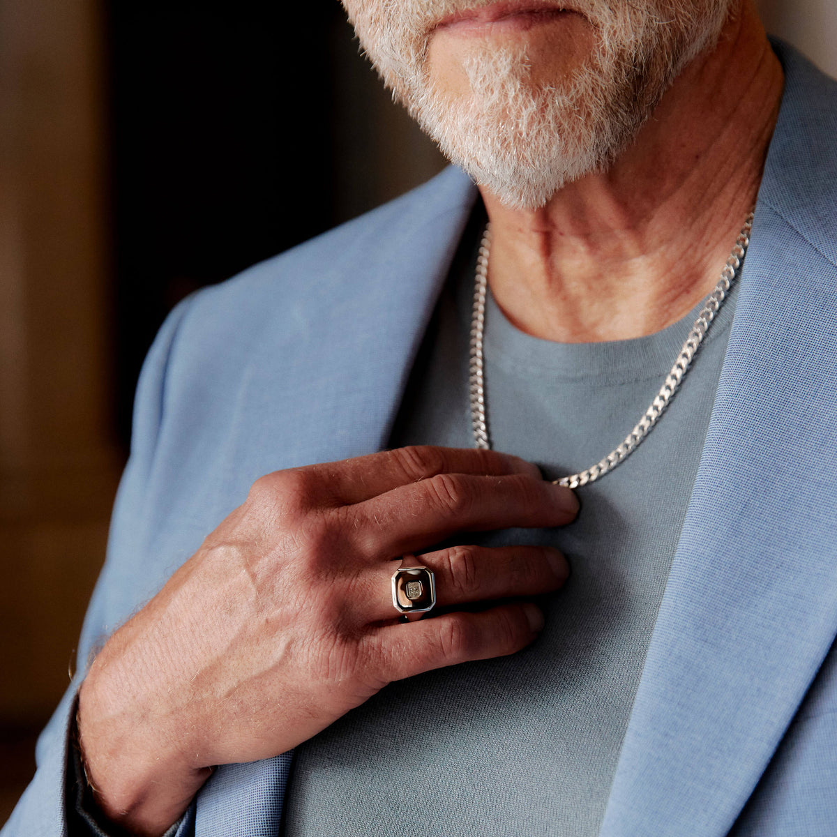 Model wearing diamond signet ring and sterling silver chain