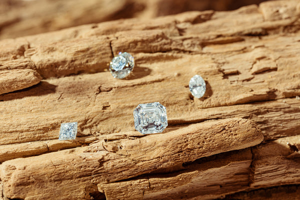 Loose reclaimed diamonds resting on driftwood