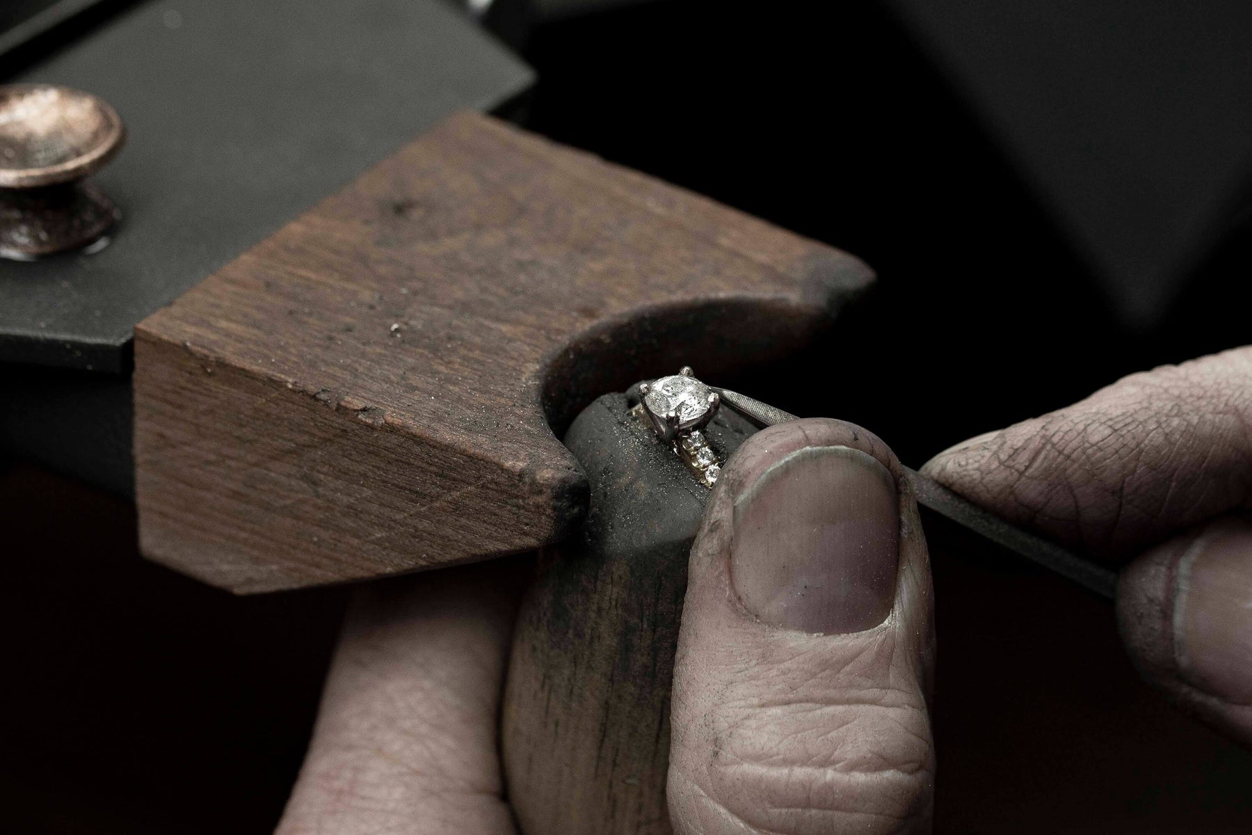 Diamond setter setting stone into ring