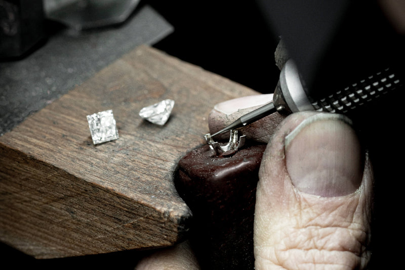 Stone setter setting diamond into ring