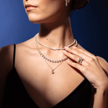 Model wearing diamond 1899 Collection necklaces and rings