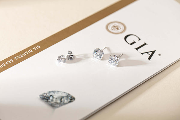 Diamond Blossom Studs resting on GIA certification