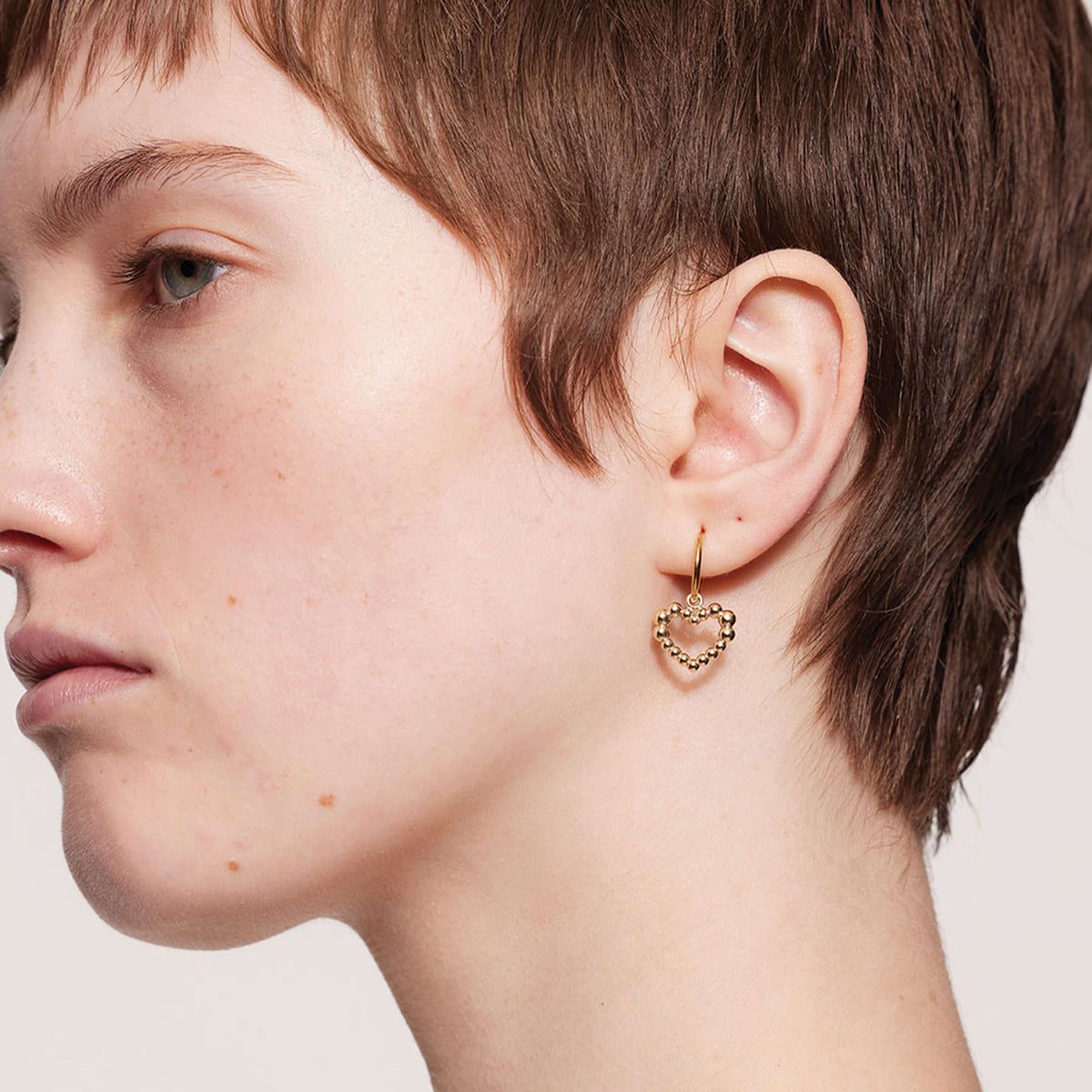 Model wearing Meadowlark Fizzy Heart Earrings