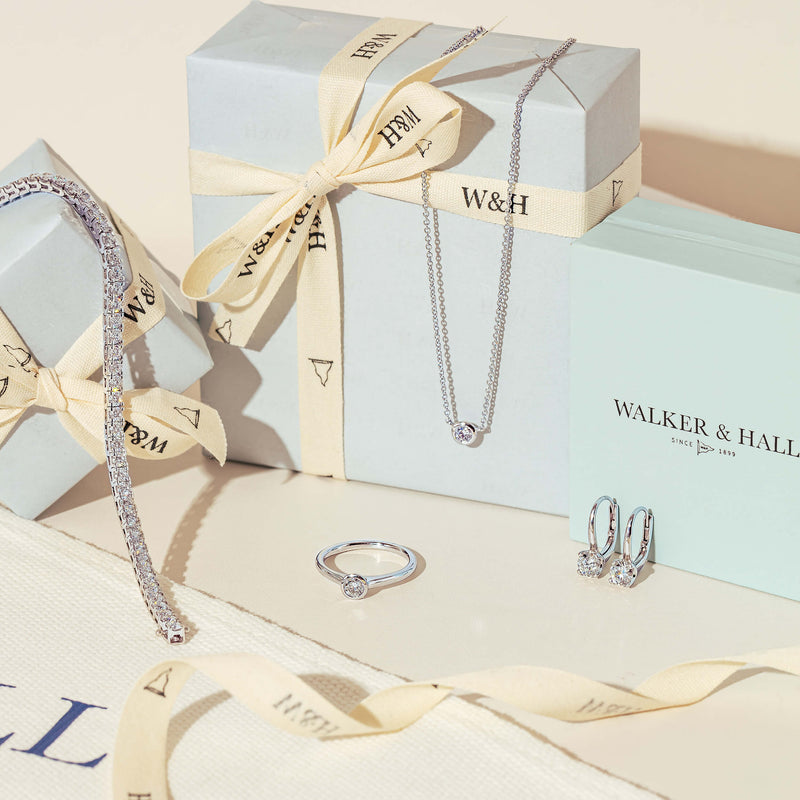 Natural diamond jewellery displayed with wrapped Walker & Hall gift boxes