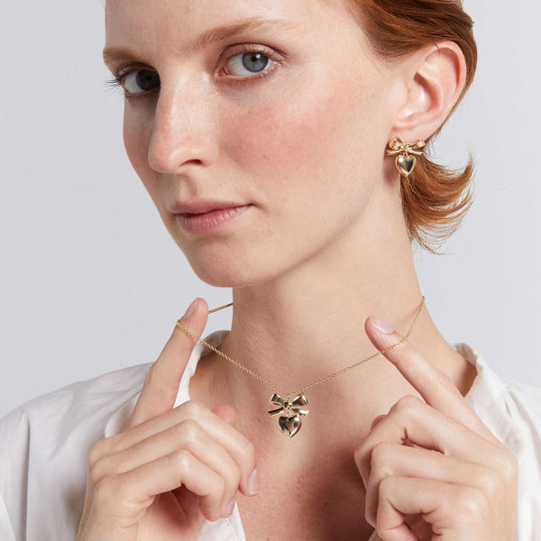 Model wearing Karen Walker pendant and earrings