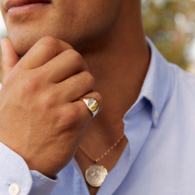 Model wearing signet ring and sovereign pendant