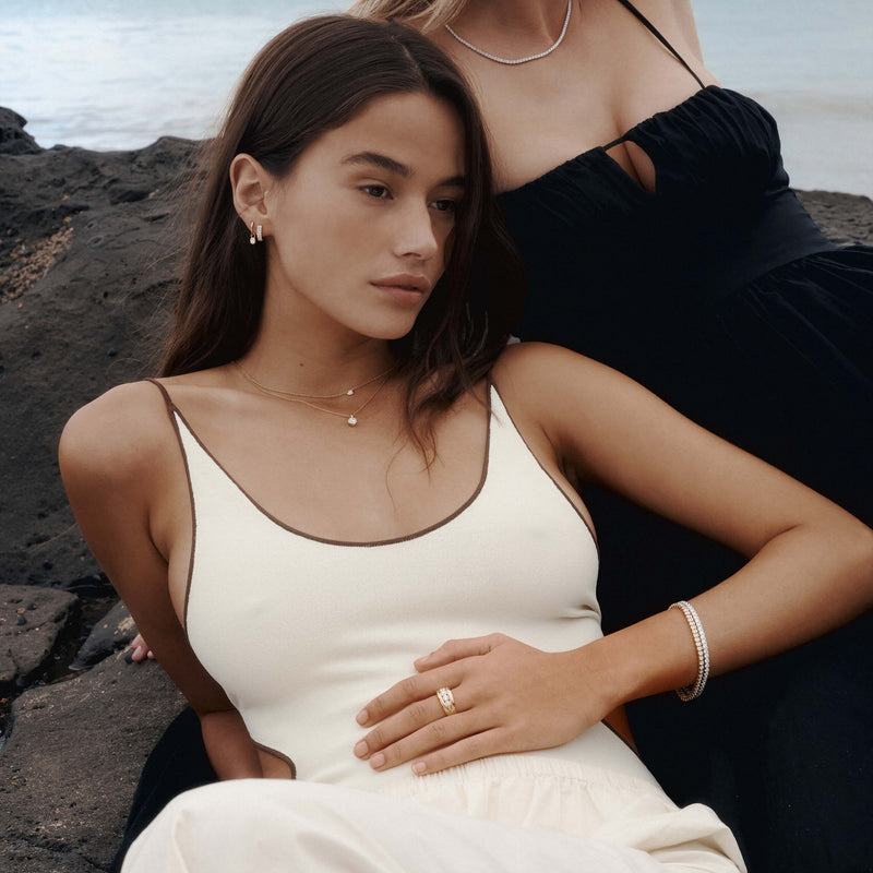 Model on NZ beach wearing selection of gold and diamond jewellery