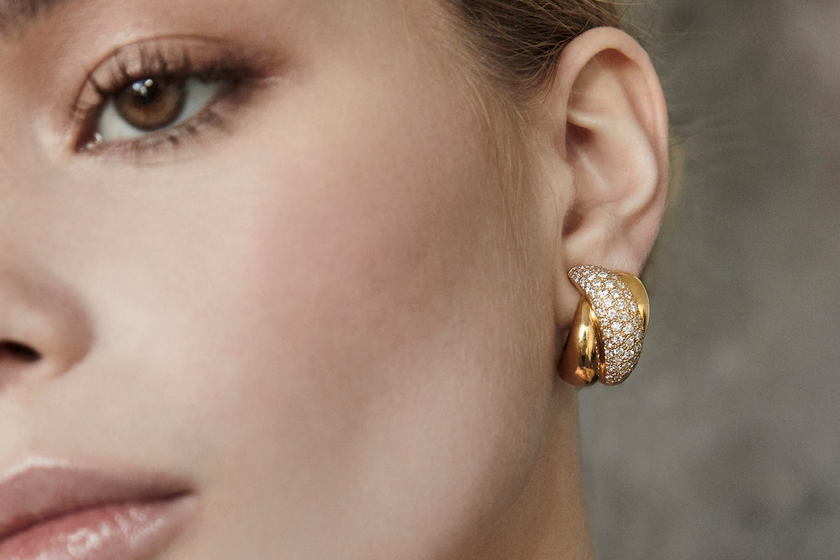 Model wearing yellow gold and diamond Contemporary style earrings