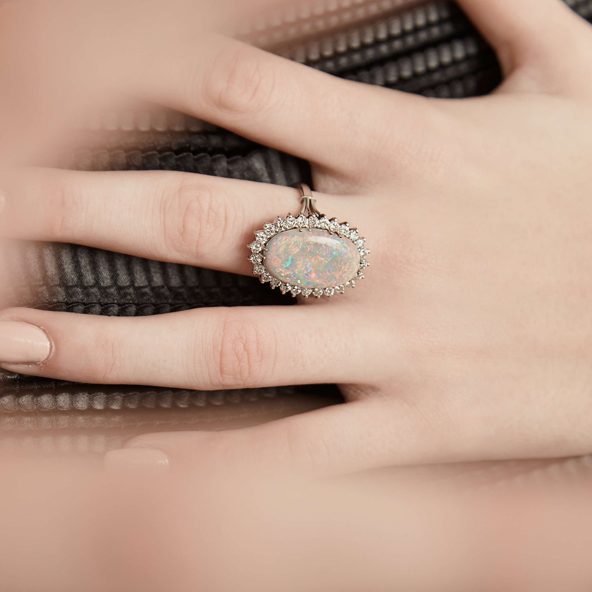 Model wearing opal and diamond Modern style ring