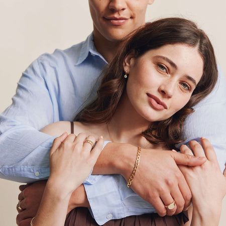 Couple embracing wearing gold and diamond jewellery