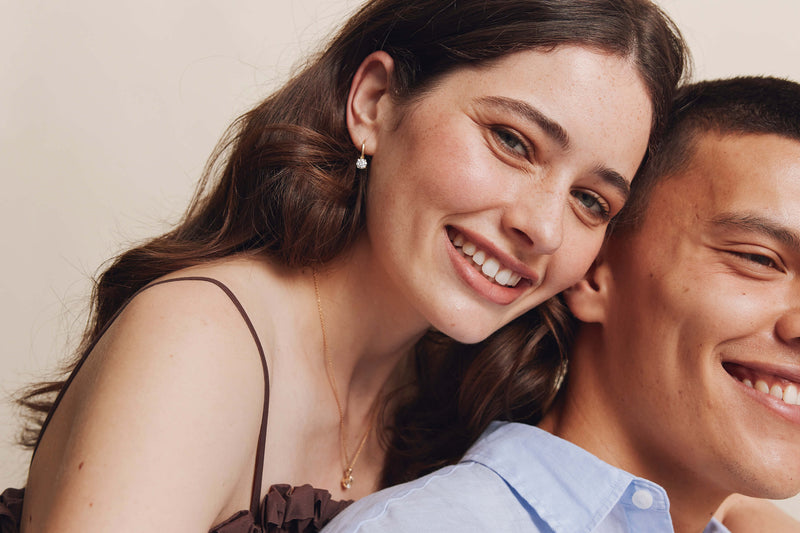 Couple embracing, model wearing Diamond Blossom Drop Earrings