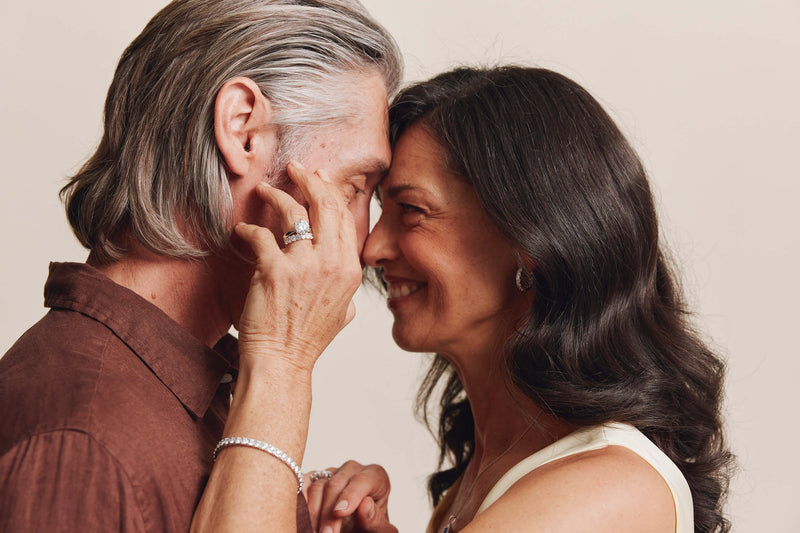 Couple embracing, model wearing diamond rings, earrings and bracelet