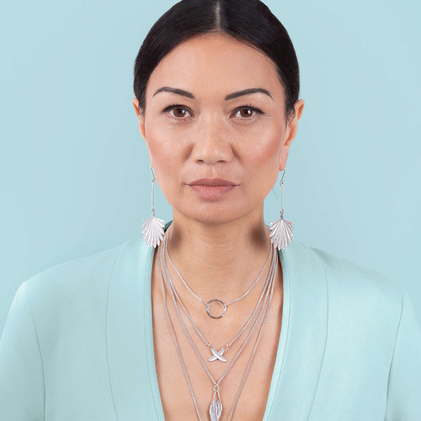 Boh Runga wearing various necklaces and earrings